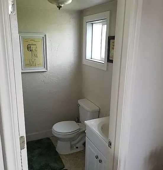 Step down into the half bath and laundry room.