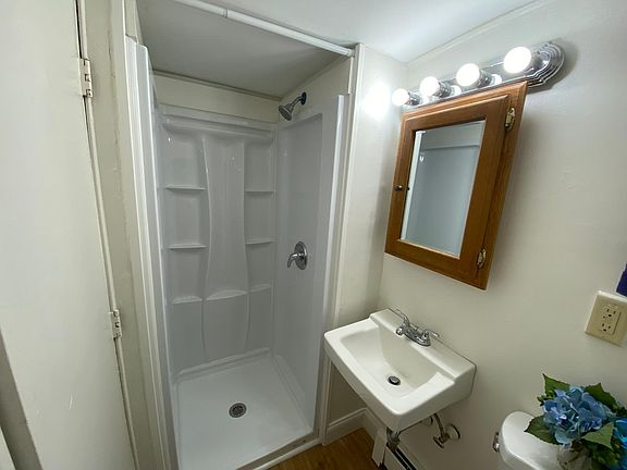 Newly renovated bathroom featuring a brand-new Delta Classic 500 shower with built-in shelves.