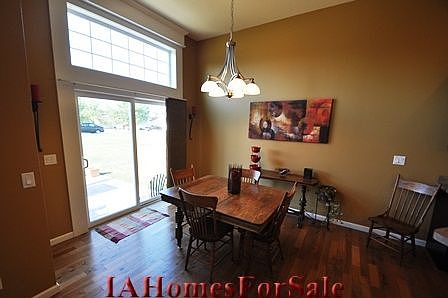 Large dining area with sliders that are flanked by custom trim and features a transom window above.