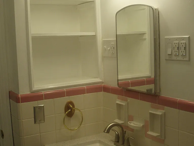Full bath includes a large shelving area for much storage, as well as medicine cabinet.