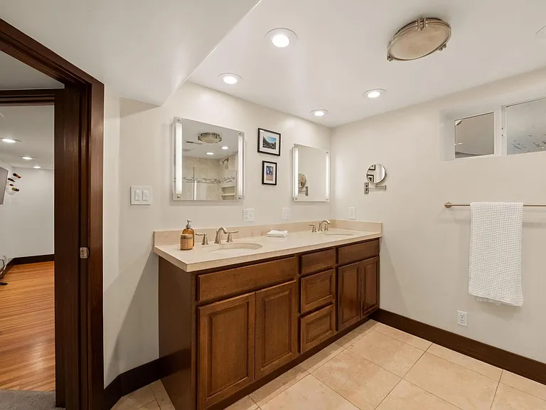Basement level full bathroom, double sinks, walk in shower