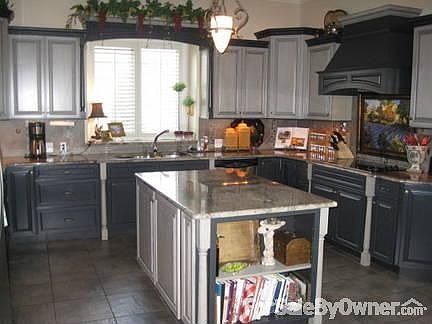 Kitchen : Custom cabinets with stainless steel appliences and granite countertop.