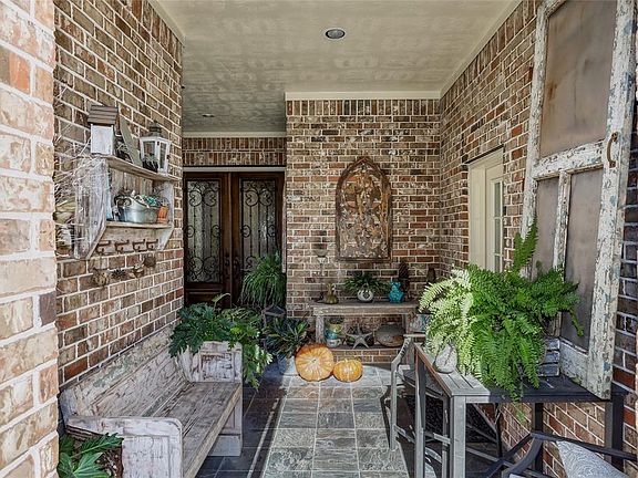 Welcome to your new home. Walk through the iron gated entrance to enjoy this front patio.