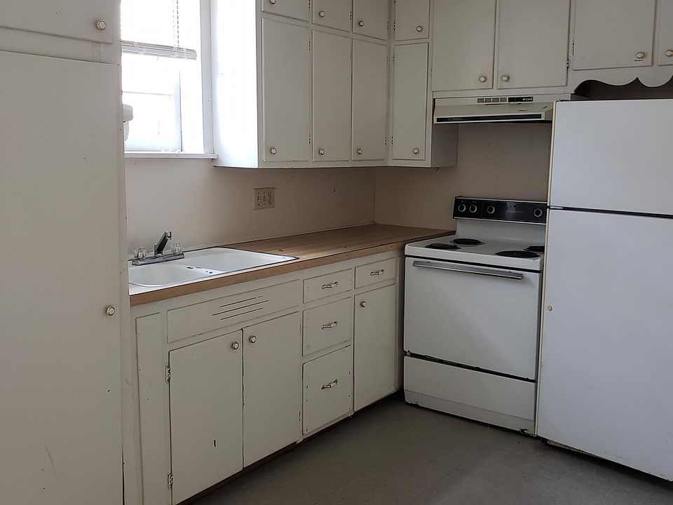 Eat in kitchen showing lots of cabinets, stove and refrigerator