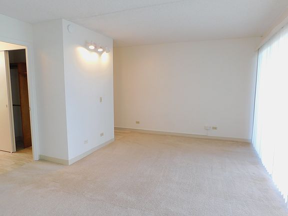 Bathroom/dressing area and kitchen access on left side.