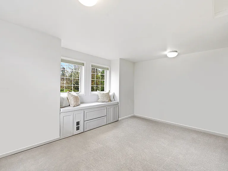 South end of Bedroom 2 (pictured vacant) but now has a queen bed. This bedroom is very large and the window seat is a great spot to read or look across at views out the north window.