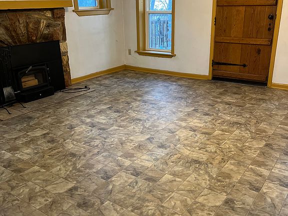 Entry small setting room, beautiful old door and fireplace. ceiling fans in all rooms but kitchen.