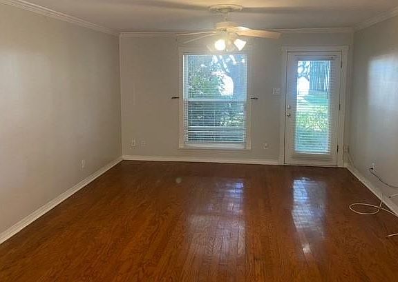 Large living room area with glass front door that opens to courtyard area.