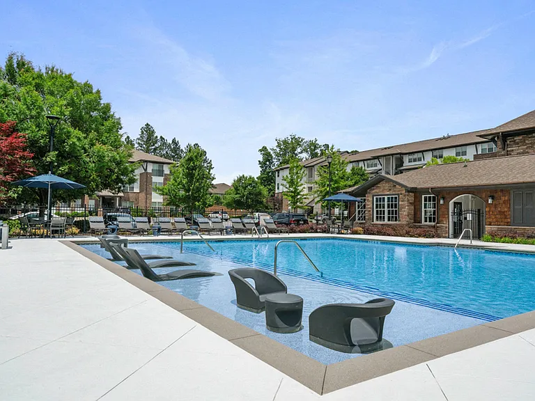 Resort-style pool with sun shelf and ample loungers