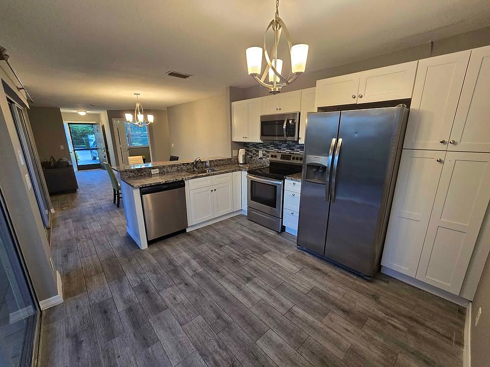 Kitchen with Stainless steel appliances, granite counters and tile floors