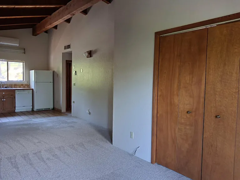 Living room with doors to second bedroom