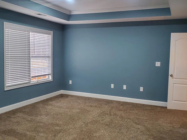 Extra large master bedroom with space for sitting area or office.
