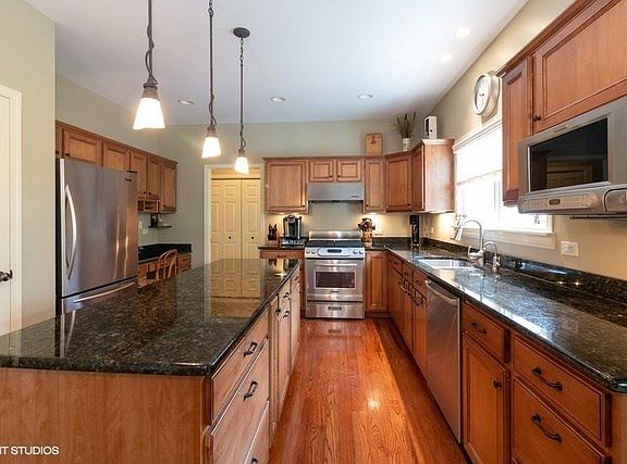 Maple cabinets have pull out drawers, Island and Classic Granite Counters.