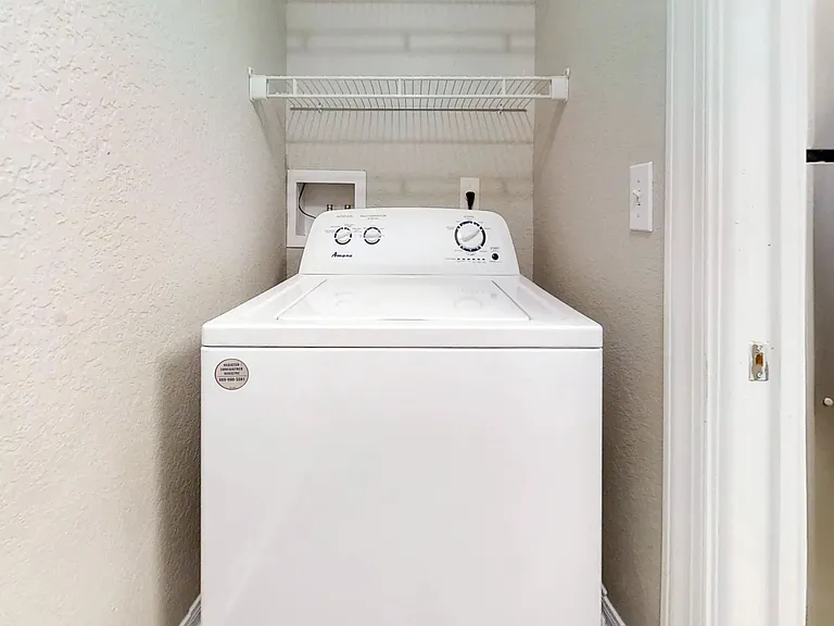 The Chateau offers a private laundry nook equipped with a full-size washer and dryer and built-in shelving to keep your space organized and efficient.