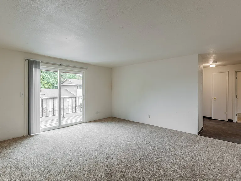 Enjoy an open-concept living room filled with natural light at Fox Pointe Apartments in Portland, Oregon.