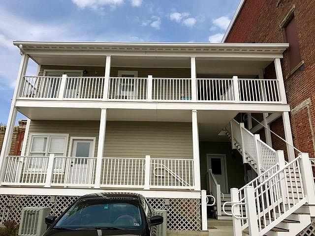 Rear porch and private parking lot