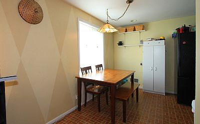 Dining Room has unique accent painting on the wall, and lovely chandelier & window for plenty of lig