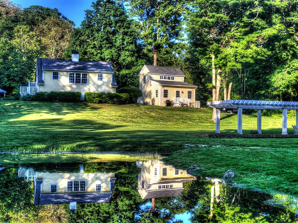 Backyard view of property. Cottage on right.