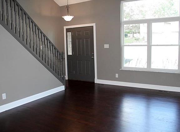 Refinished hardwood floors and tall baseboards