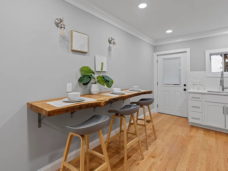 Kitchen (2) with kitchen table mounted to the wall made from a fallen Balt City Tree with a real live edge
