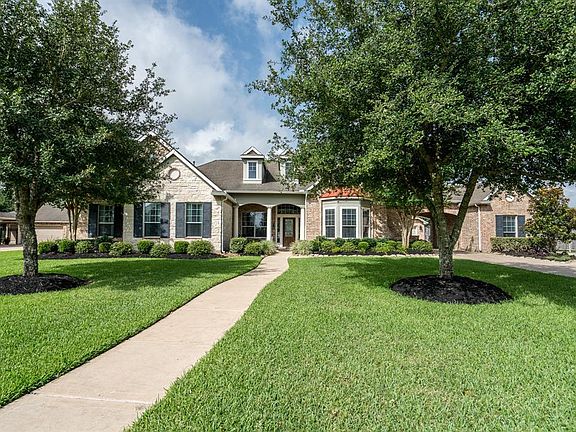 Beautiful brick and stone elevation with traditional dormers, tin roof accents and a lush yard with mature trees offers great curb appeal. Full gutters and a sprinkler system help maintain the outer appearance of this amazing home!