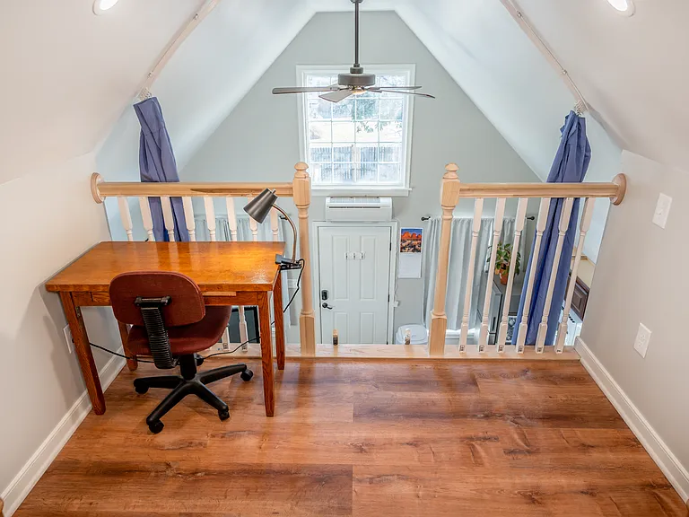 The desk in the loft provides a dedicated work space with a great view through the large living room window. Adjustable privacy curtains also provide separation for guests or while you work