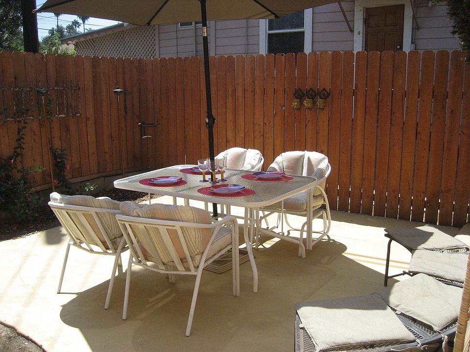 Cute back patio with privacy fence & painted concrete.