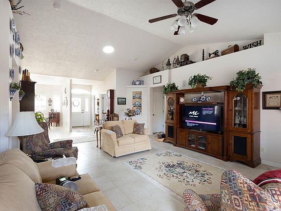 Spacious living room has fireplace & patio access. Furnishings are previous owners.