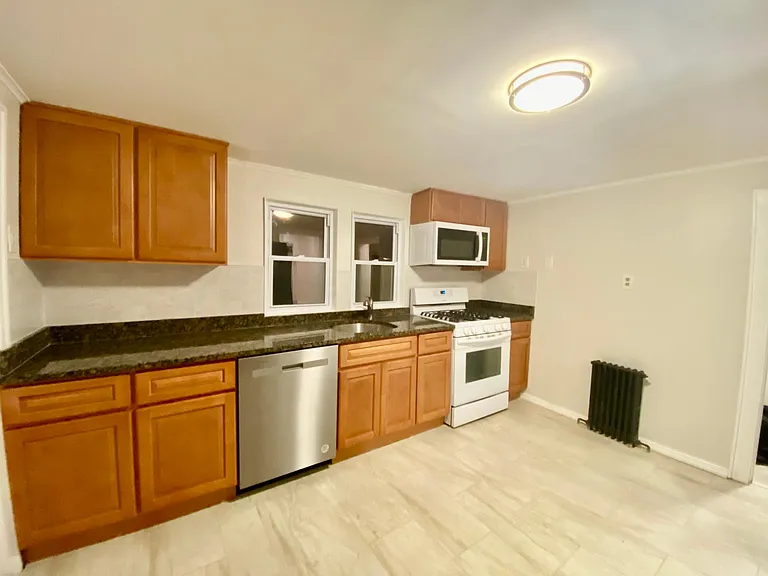 new kitchen, dishwasher, microwave, granite counter top, subway backsplash, 12 x 24 floor tiling, LED lighting, built in garbage/recycling bins.