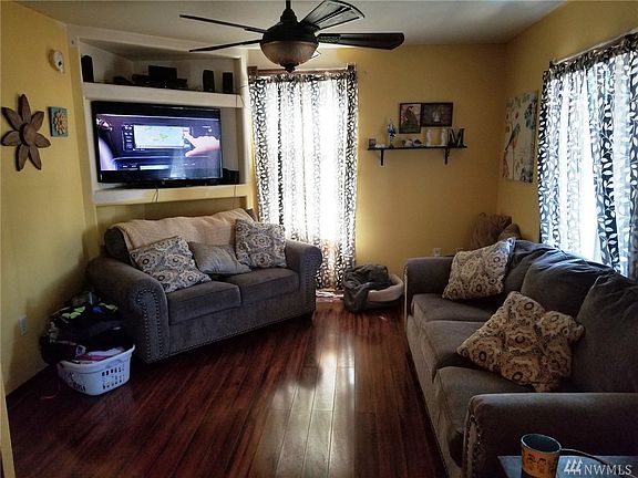 The cozy living room has original hardwood floors. 