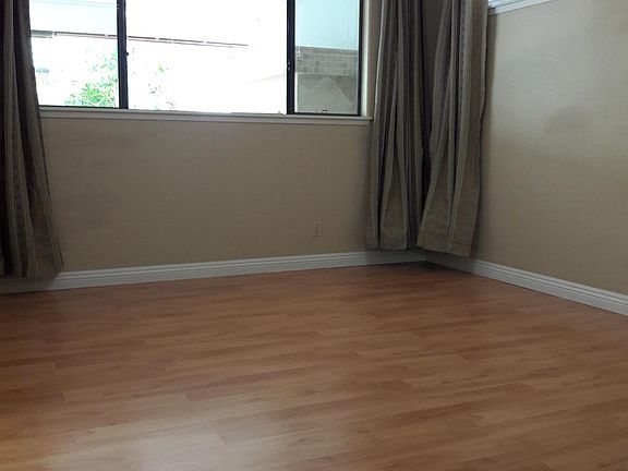 Downstairs bedroom overlooks backyard and patio