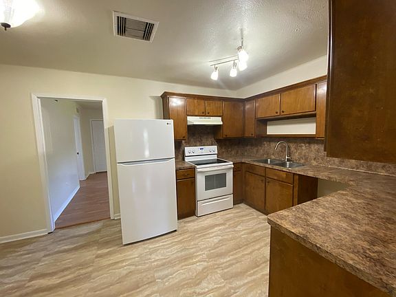 Kitchen has new tile, refrigerator and dishwasher.