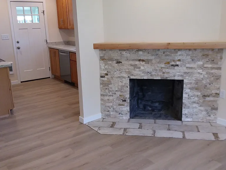 Living room with updated fireplace .
Electric insert not shown