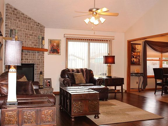 Fireplace in great room that is beautifully done in brick floor to ceiling. Open, spacious great room with brand new wood floors.