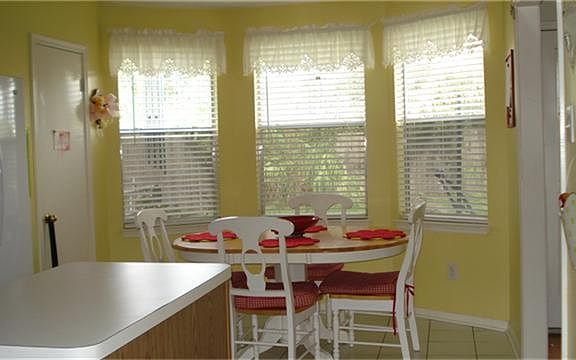 Breakfast room with a lot of window light looking out on back yard