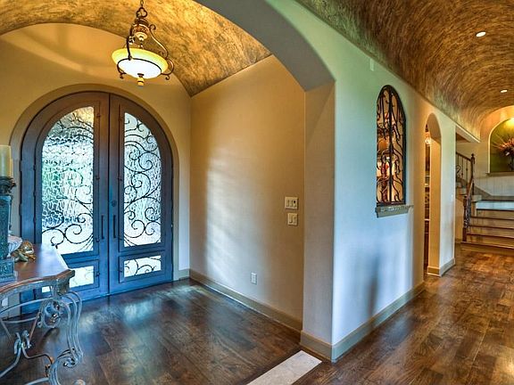 The custom details and designer touches are seen immediately upon entering the home. The 9 ft hand-forged cantera doors, barrel ceiling, and hickory wood floors are rich in style.