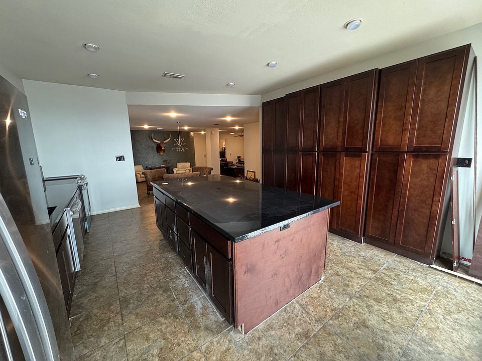 New kitchen cabinets, epoxy countertops, and appliances- looking towards dining area.