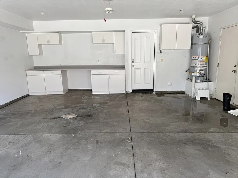 2 car garage with a lot of storage space and new water heater