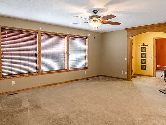Here is a nice view of the living room right off the entry of the house. The Pellet Stove stayswith the house for more energy efficient heating costs.  Large windows to enjoy natural light