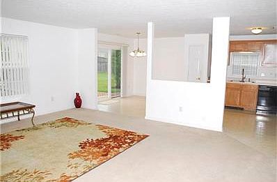 Living room adjoins eat-in kitchen