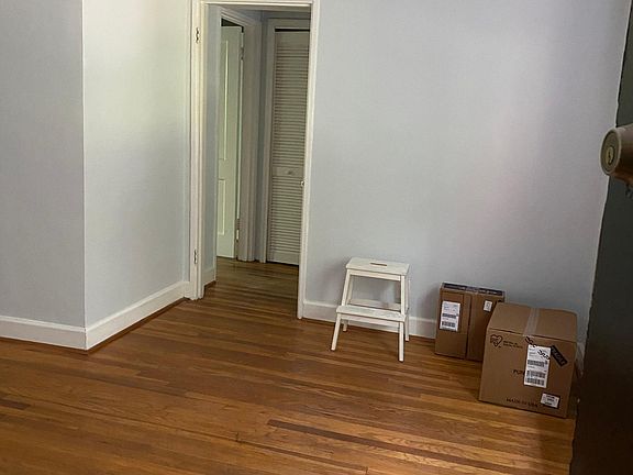 Looking from front door into hallway to bedroom, bathroom, and laundry closet