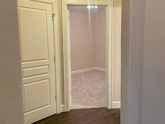 To the left of the entry