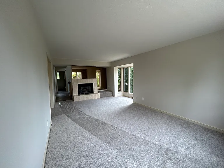 Living room with fireplace and bay box windows