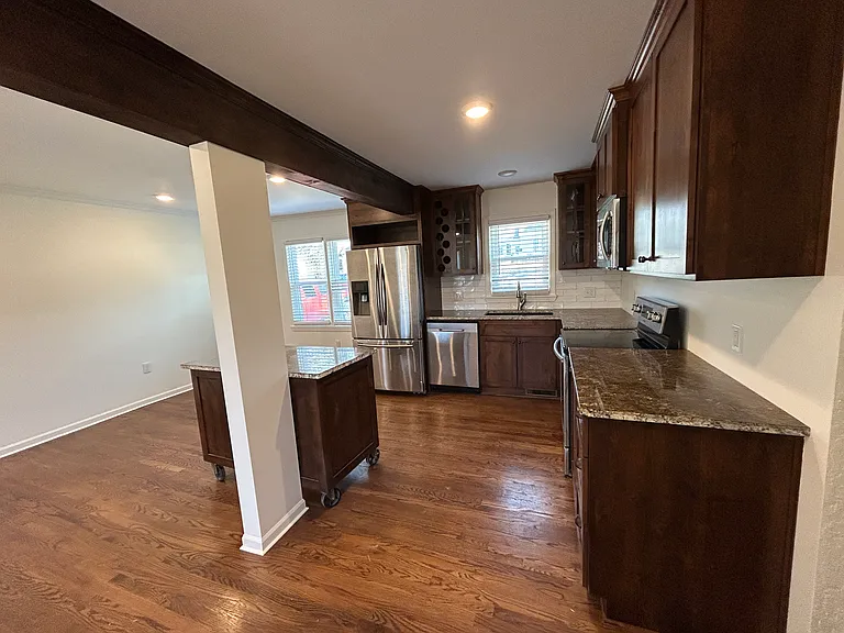 Space for dining room near kitchen. Rolling island with marble countertop and additional storage space.
