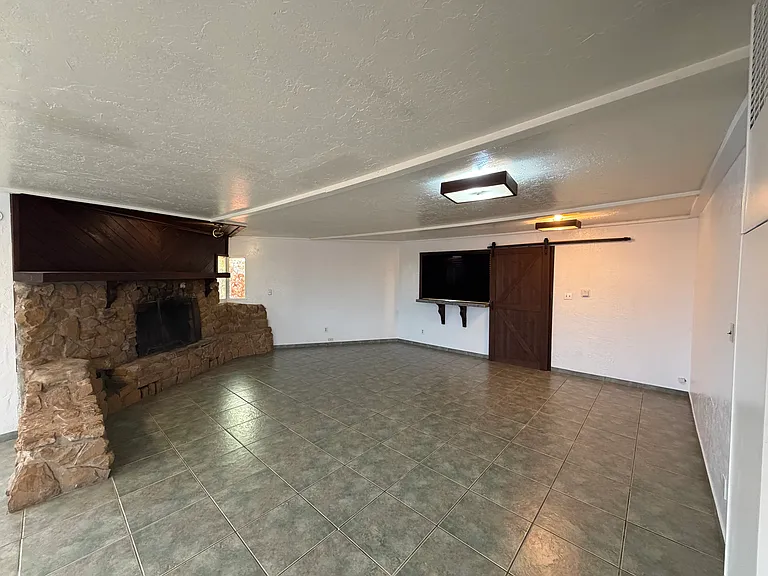 The entertainment room has a stylish barnyard door and breakfast nook that close for privacy.