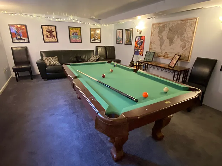 Basement game room with pool table (converted from ping pong) and couch
