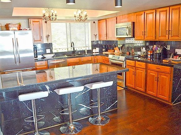 Kitchen photo from previous owner. The black stone surfaces