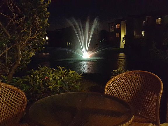 Beautiful view of the lake and fountain at night as well