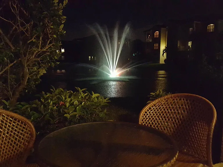 Beautiful view of the lake and fountain at night as well