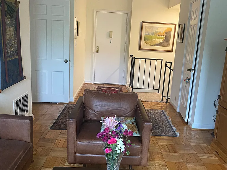 Main entrance on upper level with view of stairway to lower level and entrance to the bathroom and the bedroom on the left. There is coat closet on the right.